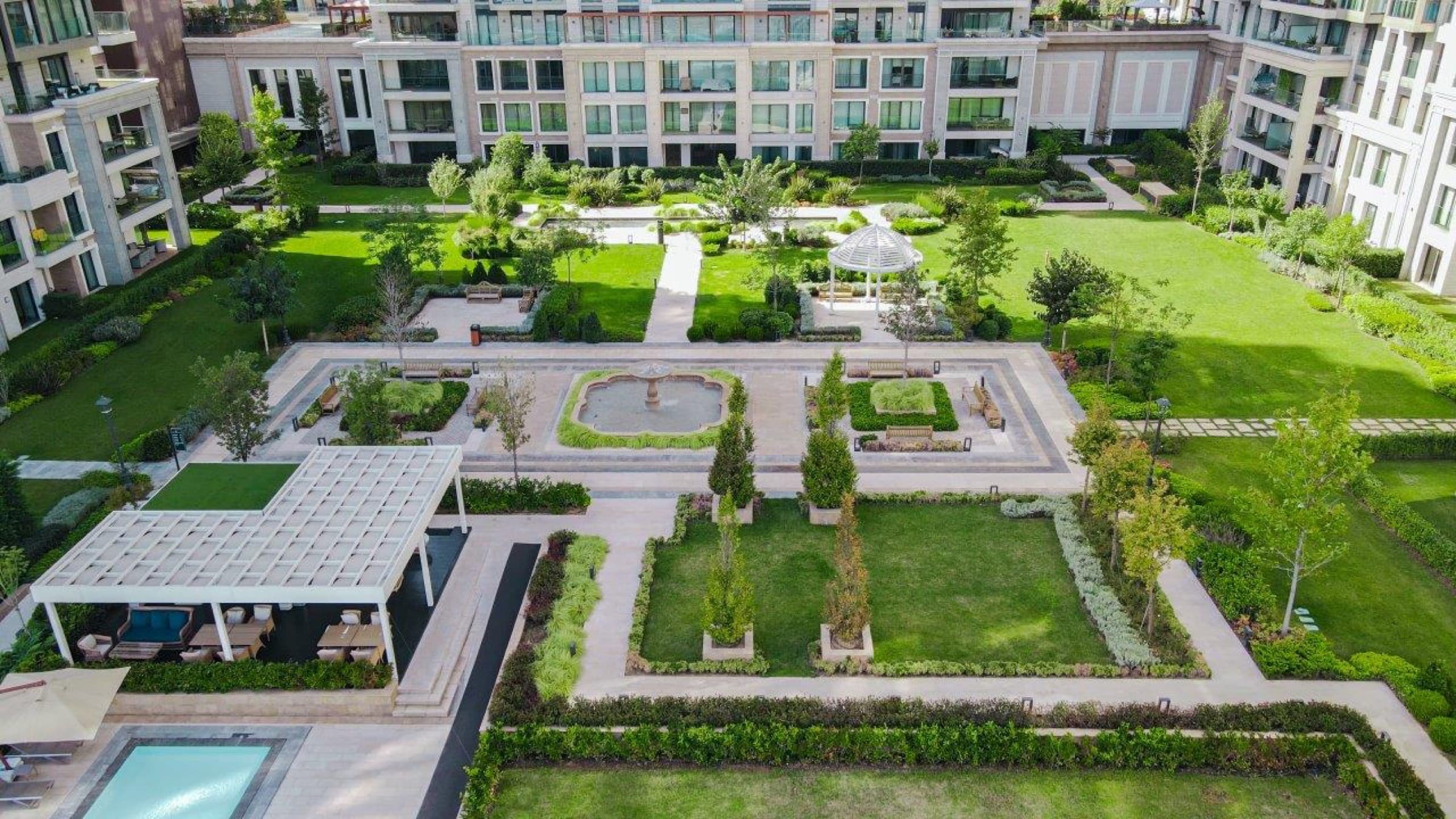 Formal central gardens from above, with a fountain court, gazebo and poolside cabana between the blocks