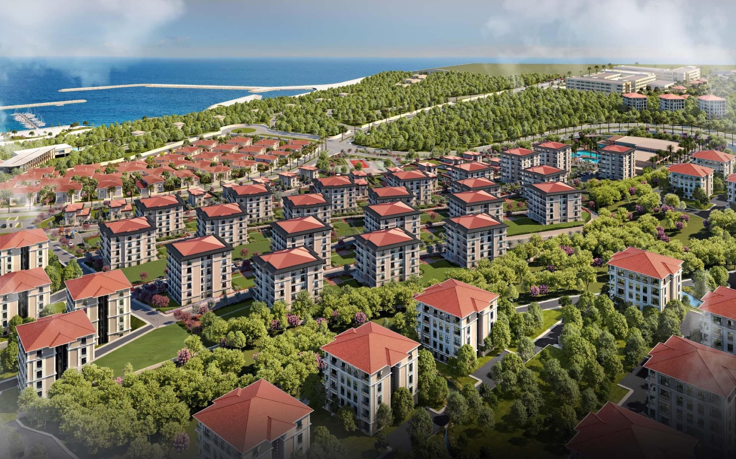 Deniz İstanbul'da Sedef Konakları'nın mimari görselleştirmesi: kırmızı çatılı blokları ve villaları çimenler ve olgun ağaçlar arasında; arkada kıyı, marina mendireği ve açık Marmara.