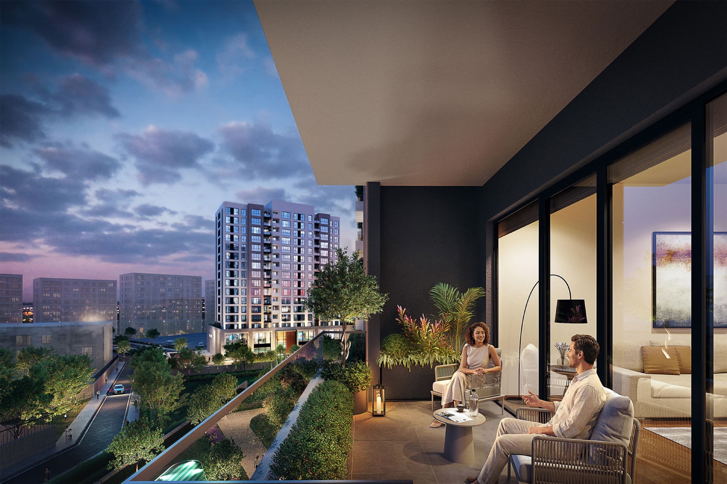 View from a Dia Centro terrace at dusk over the landscaped garden and the surrounding Zeytinburnu rooftops, with two residents seated by the glazed living-room wall