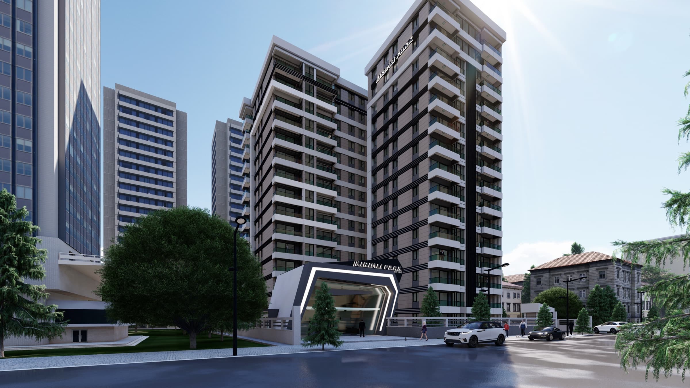 Kırımlı Park on its street corner, the angular illuminated entrance canopy set into the base of the dark tower, with the neighbouring towers of Küçükçekmece behind