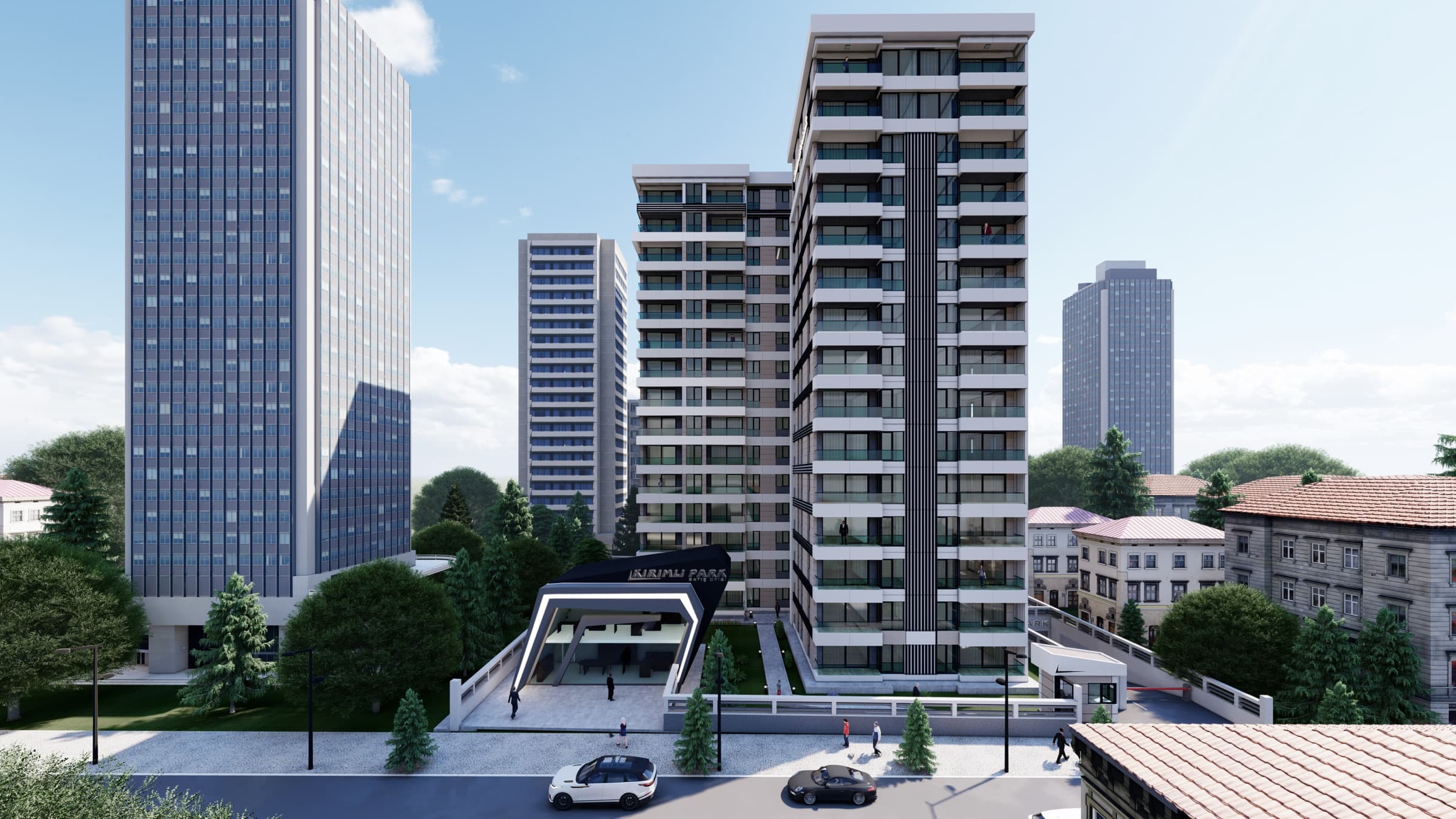Kırımlı Park seen along its street from an elevated position, the taller wing with its dark vertical spine on the right and the lower stepped wing to the left, the angular dark entrance canopy on its raised forecourt at the base, with older low-rise apartment blocks and a glass office tower alongside