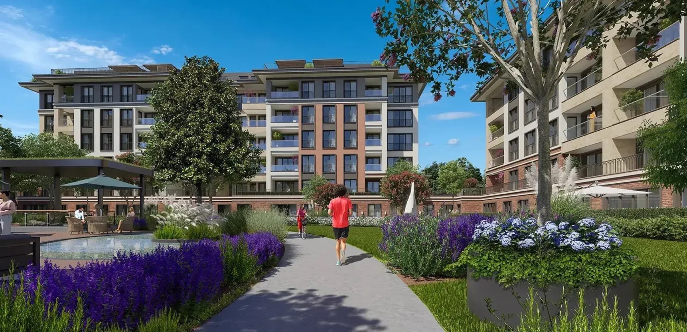 Özak Duyu Göktürk's walking and cycling path between the blocks, running past lavender borders and a shaded seating terrace to the apartment balconies beyond, Göktürk