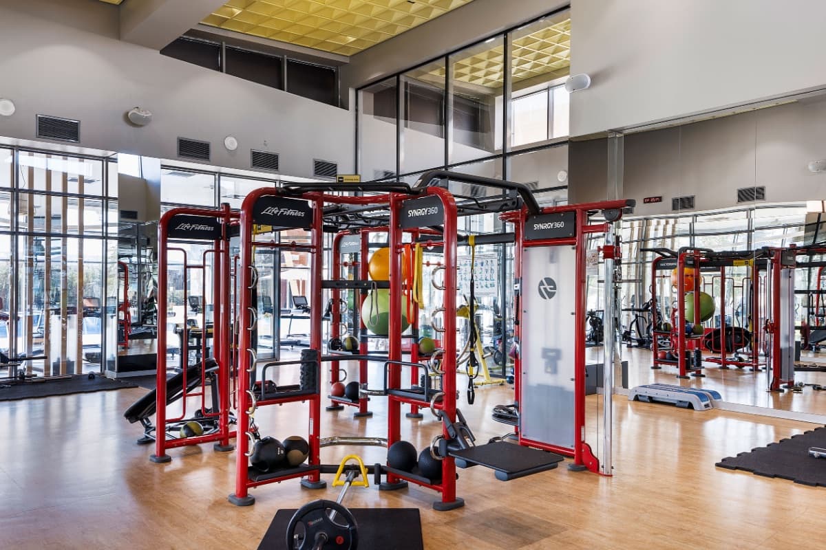 Residents' fitness centre at Tema İstanbul, with a functional training rig, free weights and mirrored walls