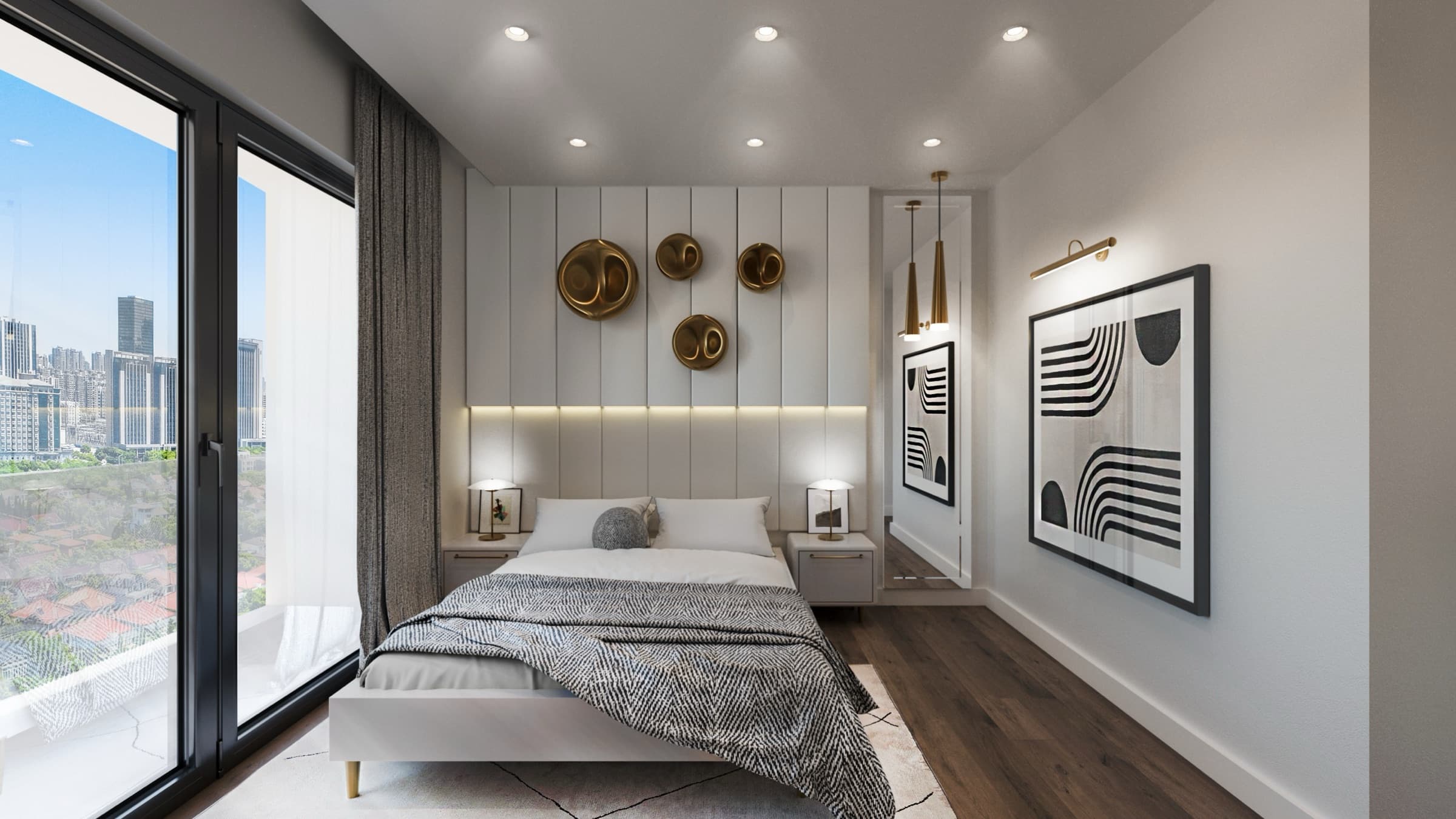 A bedroom at Venara Güneşli, brass discs mounted on a fluted headboard panel with reading lamps either side, framed prints on the facing wall, and full-height glazing along the left opening to a balcony above the rooftops and towers beyond.