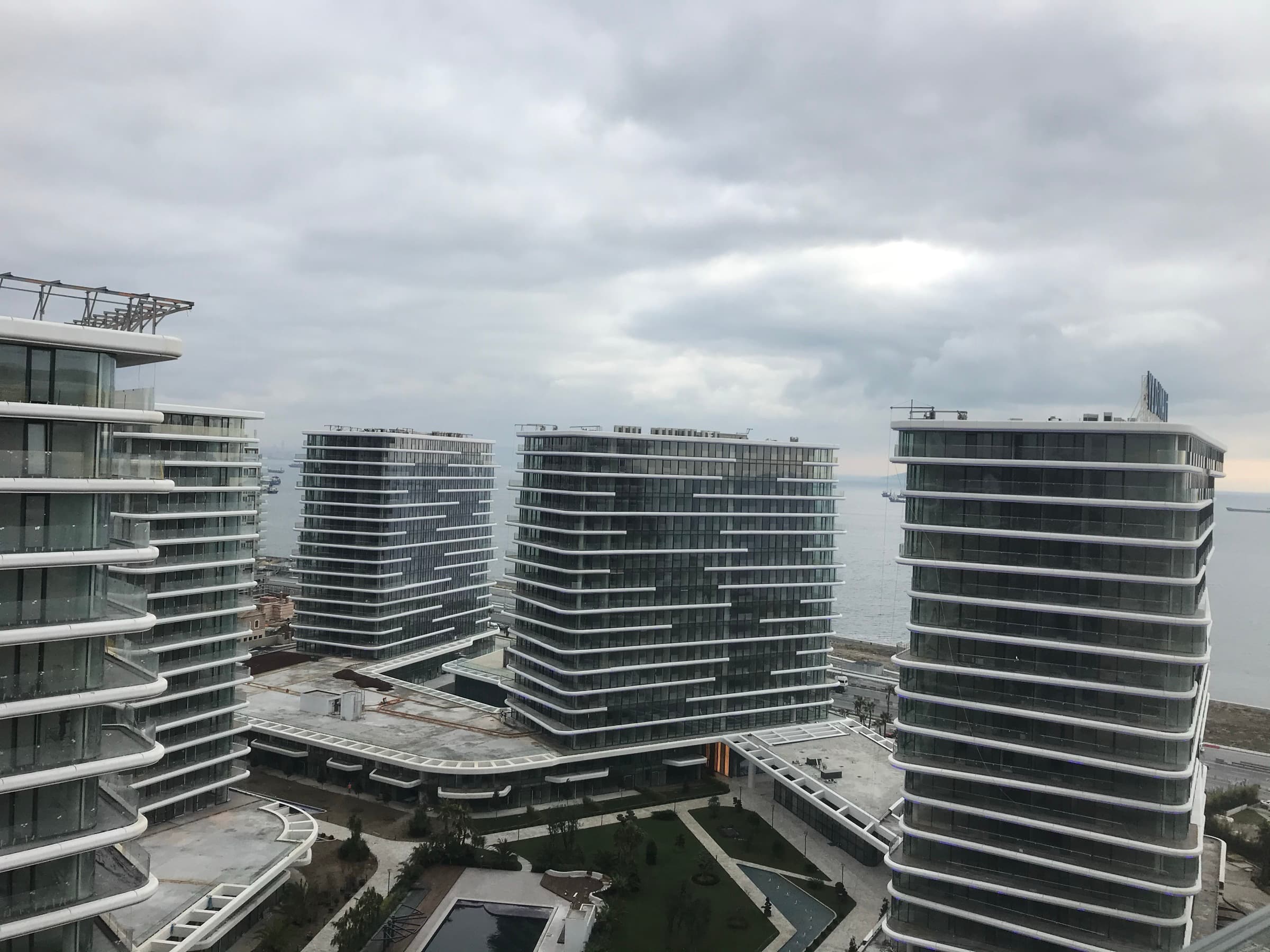 Four residential blocks at Yedi Mavi standing against the Sea of Marmara under winter cloud, ships lying at anchor offshore, Kazlıçeşme, Zeytinburnu