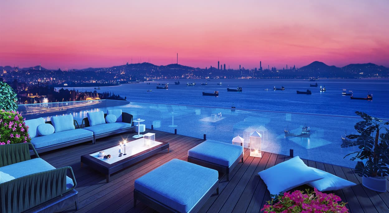 Rooftop terrace at dusk above the Sea of Marmara, with the Istanbul skyline beyond