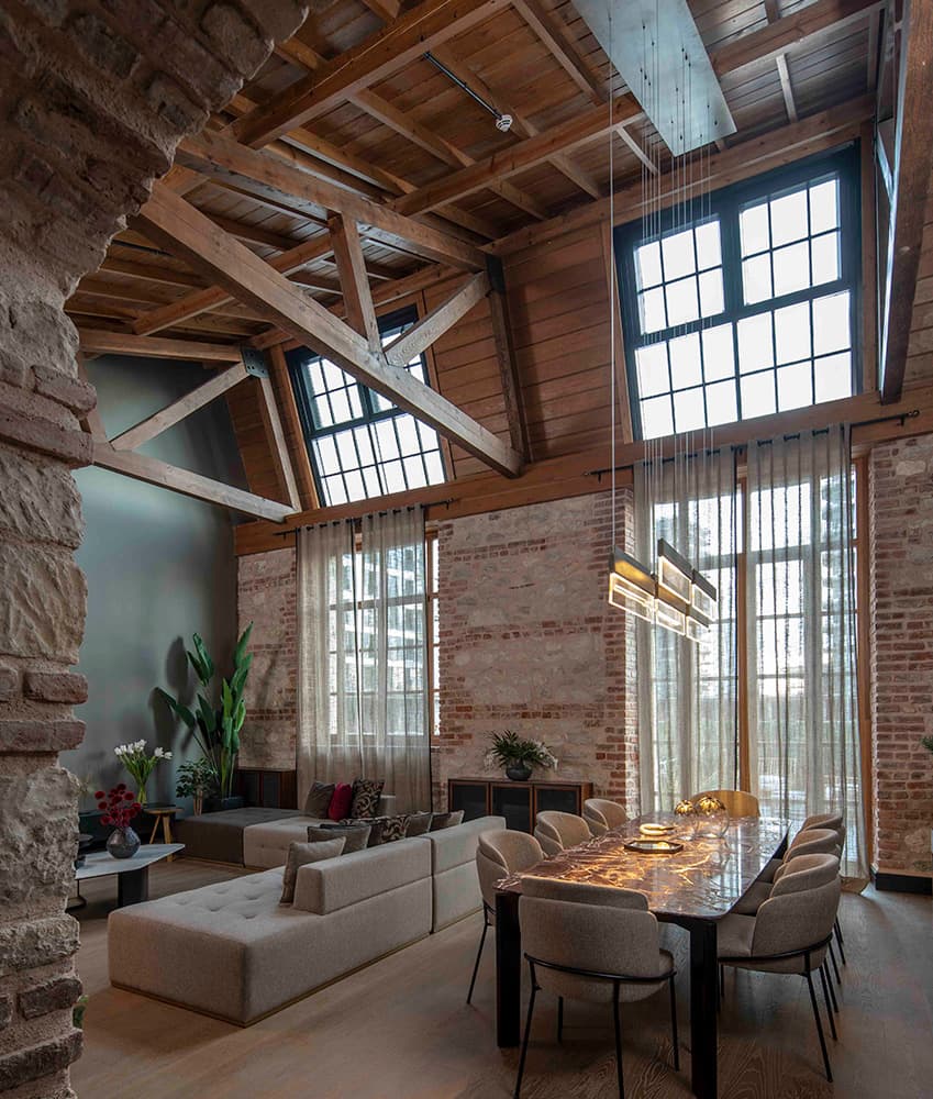 Restored loft residence with exposed timber and heritage windows in the Fişekhane building