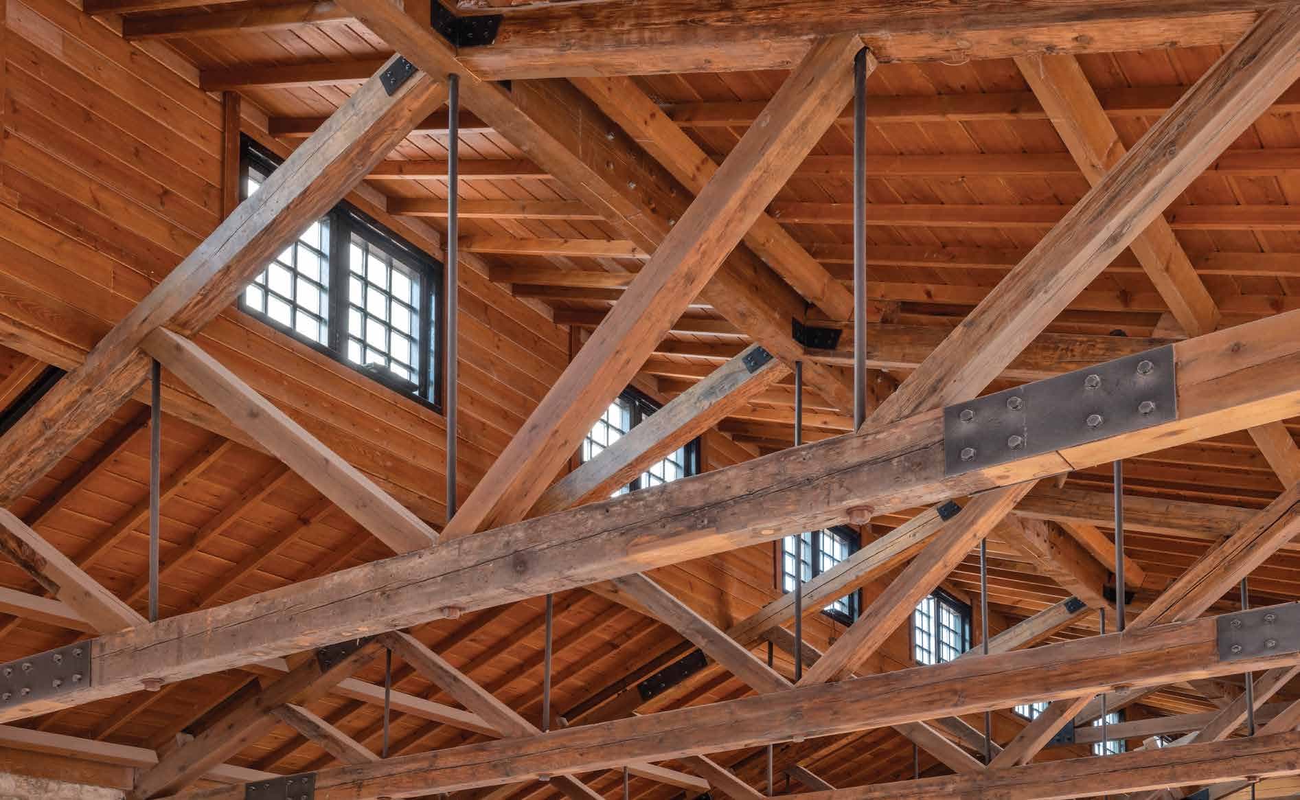 Detail of restored timber roof trusses joined with dark steel plates and bolts